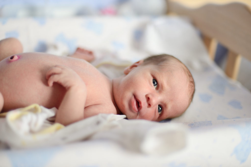 tiny newborn with open eyes