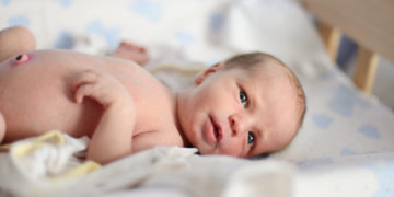 tiny newborn with open eyes
