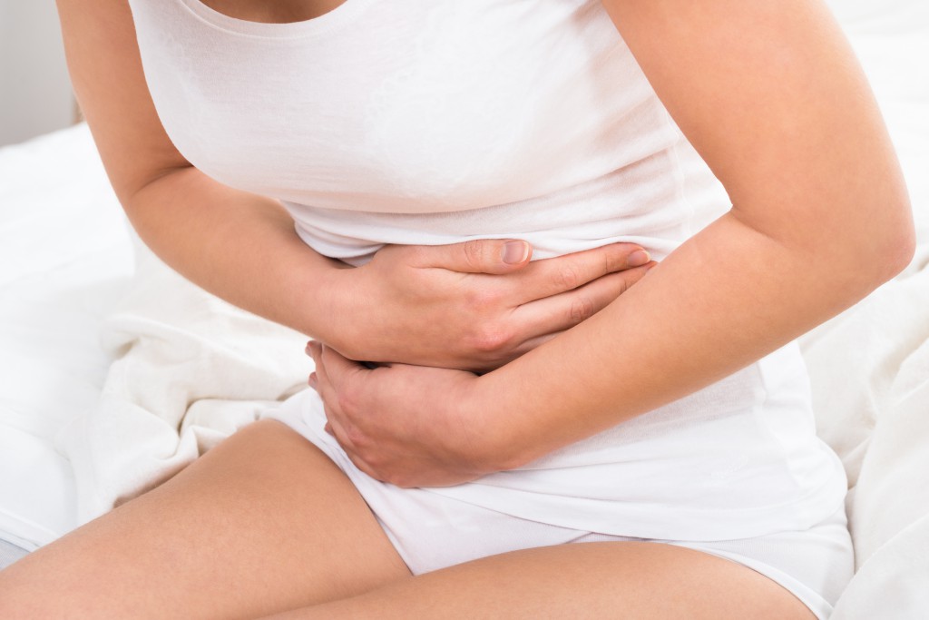 Close-up Of Woman Suffering From Stomach Ache