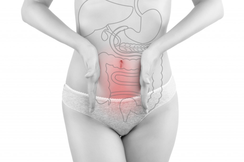 Intestine pain. Beautiful woman photography isolated on white background with inner organs illustration on her body. Digestive problems.
