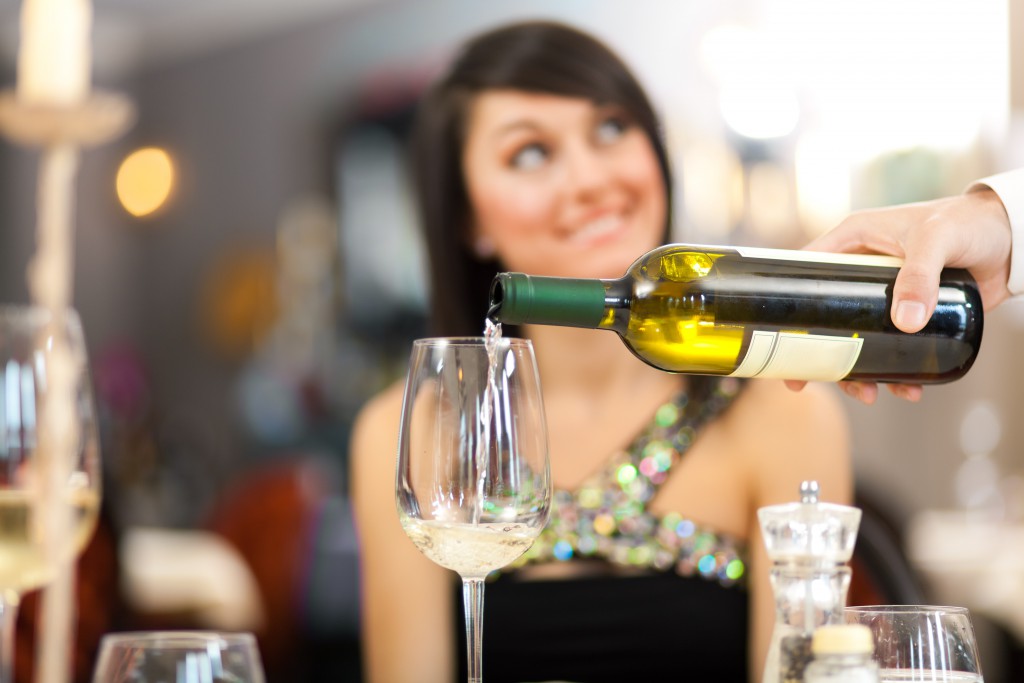 Waiter serving woman at the restaurant