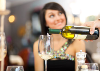 Waiter serving woman at the restaurant