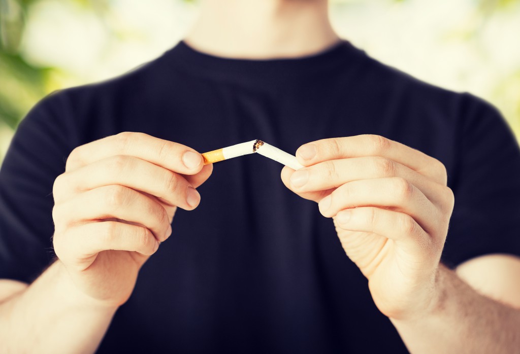 close up of man breaking the cigarette with hands