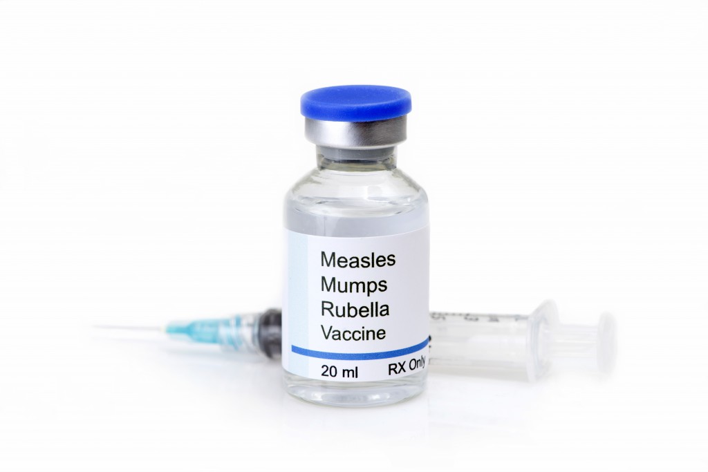 Measles, mumps, rubella, virus vaccine and syringe on white background.