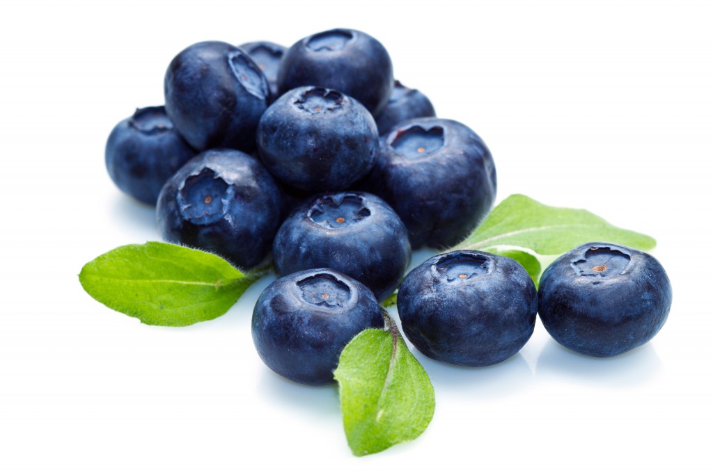 blue berry over white background and green leaf