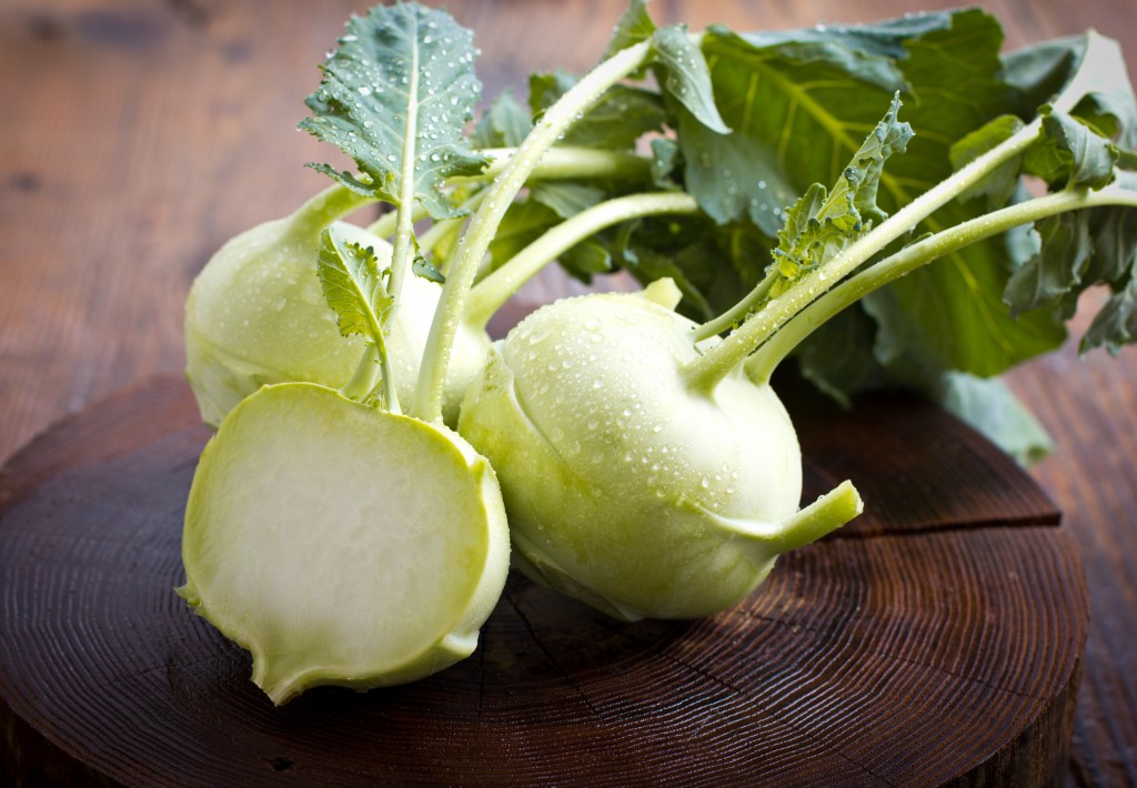 Fresh kohlrabi on the wooden table closeup