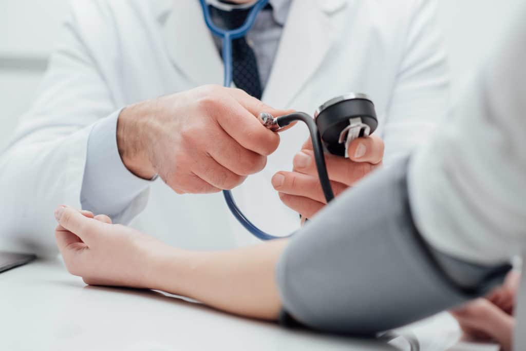 A doctor measures blood pressure