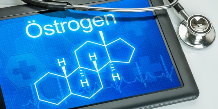 Blauer Bildschirm mit dem Schriftzug und der chemischen Formel für Östrogen sowie einem Stethoskop vor weißem Hintergrund