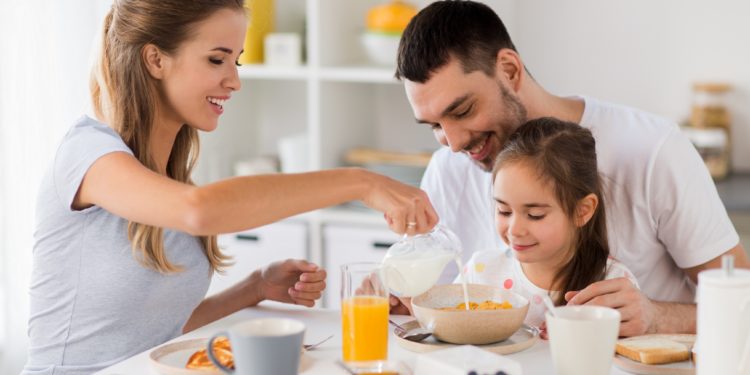 Familie nimmt Frühstück zu sich.