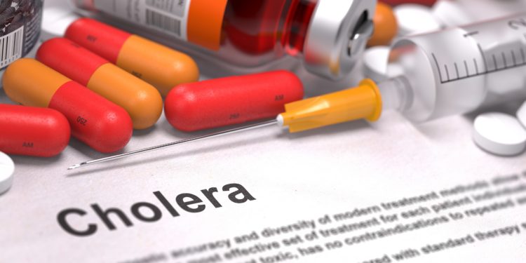 Ein Informationsblatt zu Cholera mit Tabletten, Spritze und eine Tropfflasche