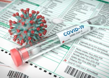 Illustriertes Coronavirus neben einem Laborprobenröhrchen mit Aufschrift COVID-19.