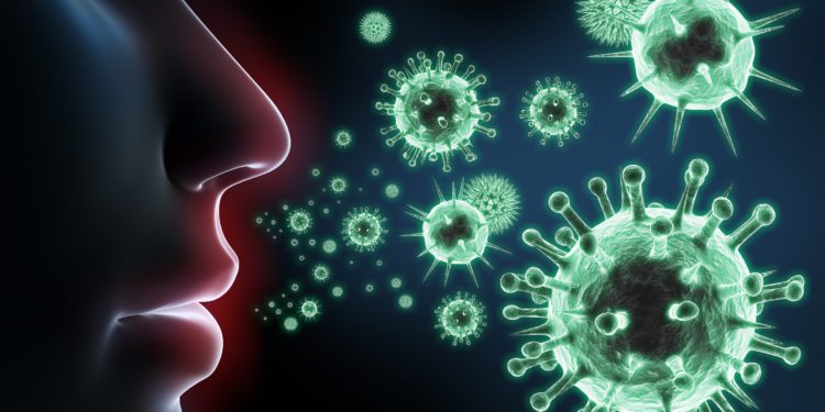 Eine grafische Darstellung einer Nase im Profil mit umherschwebenden Viren in der Luft.