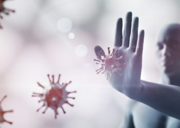 Ein Mann wehrt mit der Hand auf ihn zu kommende Viren ab.
