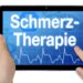 Auf einem Bildschirm wird das Wort "Schmerztherapie" angezeigt.