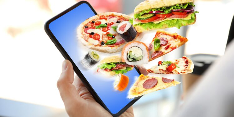 Grafische Darstellung eines Smartphones, aus dem ungesunde Lebensmittel wie Pizza und Burger herausfliegen.