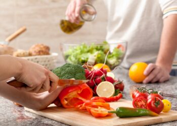 Paar bereitet zusammen einen Salat zu