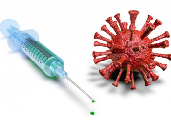 Spritze neben groß dargestelltem Coronavirus