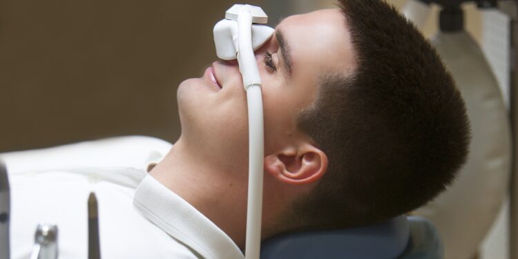 Ein junger Mann erhält Sauerstoff über ein Beatmungsgerät.