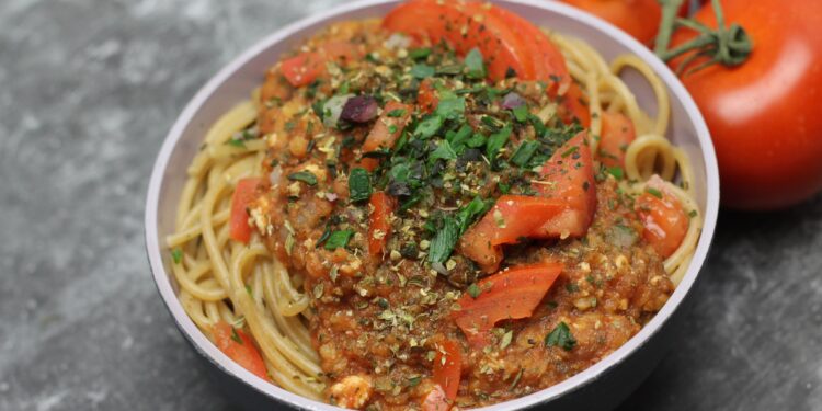 In einer Schüssel ist eine Portion Spagetti mit vegetarischer Bolognese-Soße angerichtet.