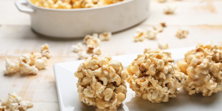 Gebackene Popcorn-Bällchen sind auf einer weißen Platte angerichtet.