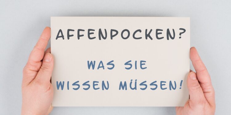 Zwei Hände halten ein Schild mit der Aufschrift: Affenpocken? Was Sie wissen müssen!