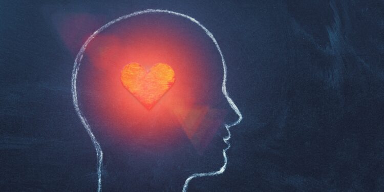 Grafische Darstellung von einem leuchtenden Herz in der Silhouette eines menschlichen Kopfes.