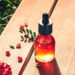 Granatapfelöl in einer medizinischen Flasche mit Granatapfel auf einem Holztisch