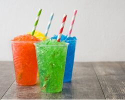 Drei Becher mit Slush-Ice auf einem Tisch.